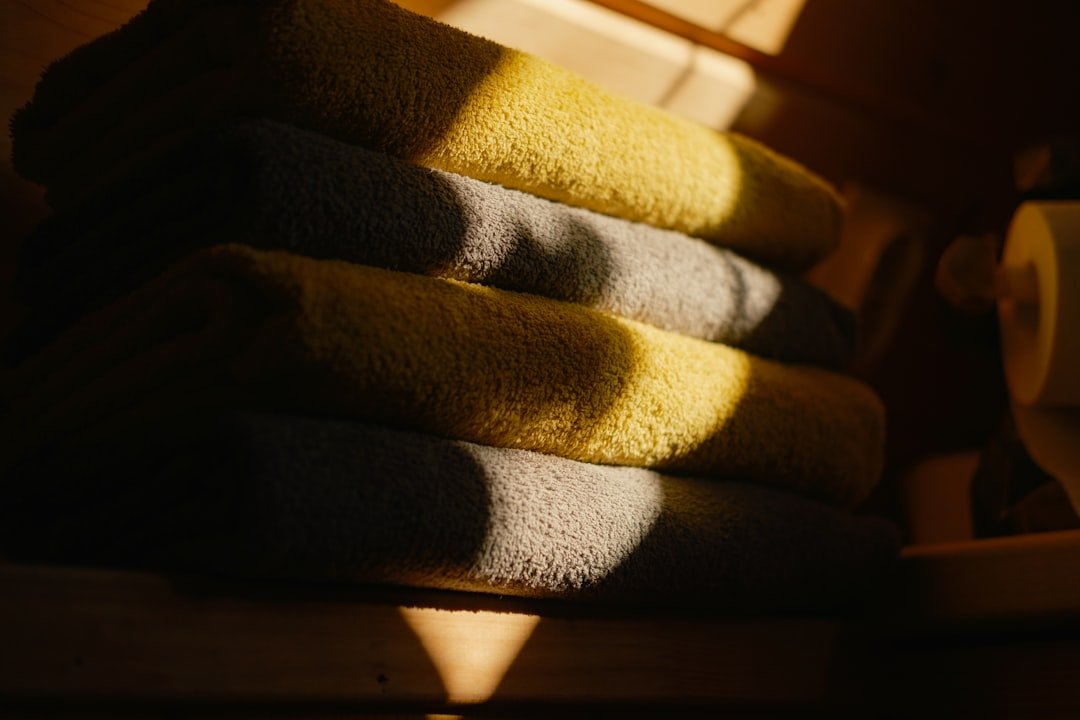 Stack of yellow and grey towels in warm sunlight